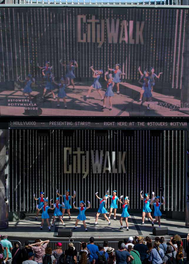 dance group performing on stage in blue