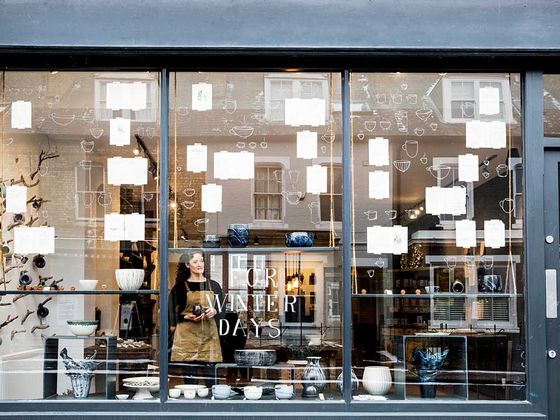 woman in the window of her shop