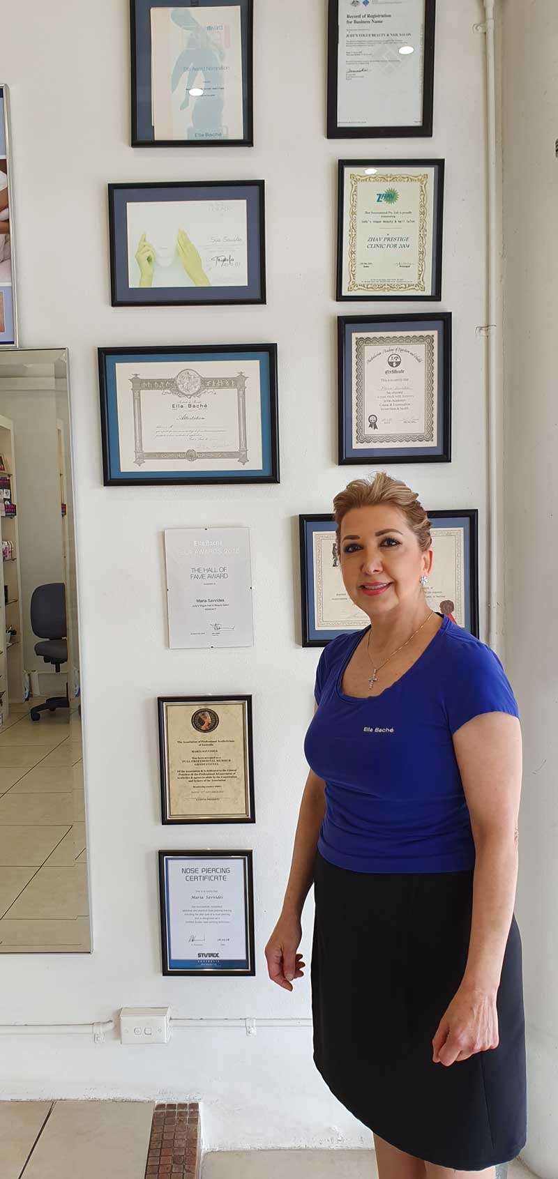 women standing in front of certificates