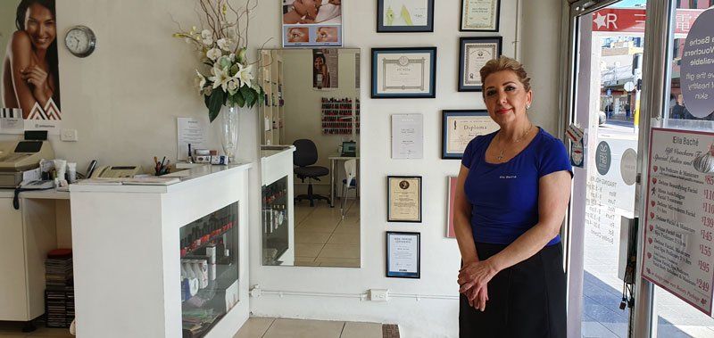 women standing in front of diplomas