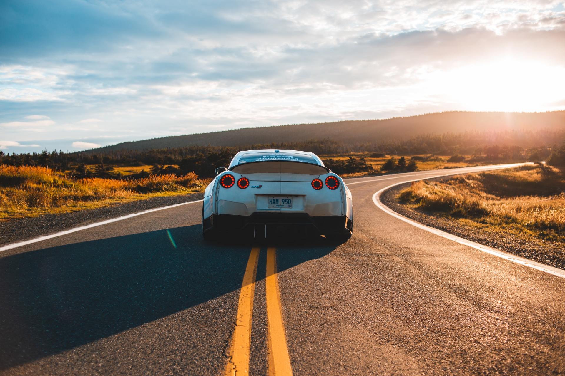A car driving down an empty road in a desert